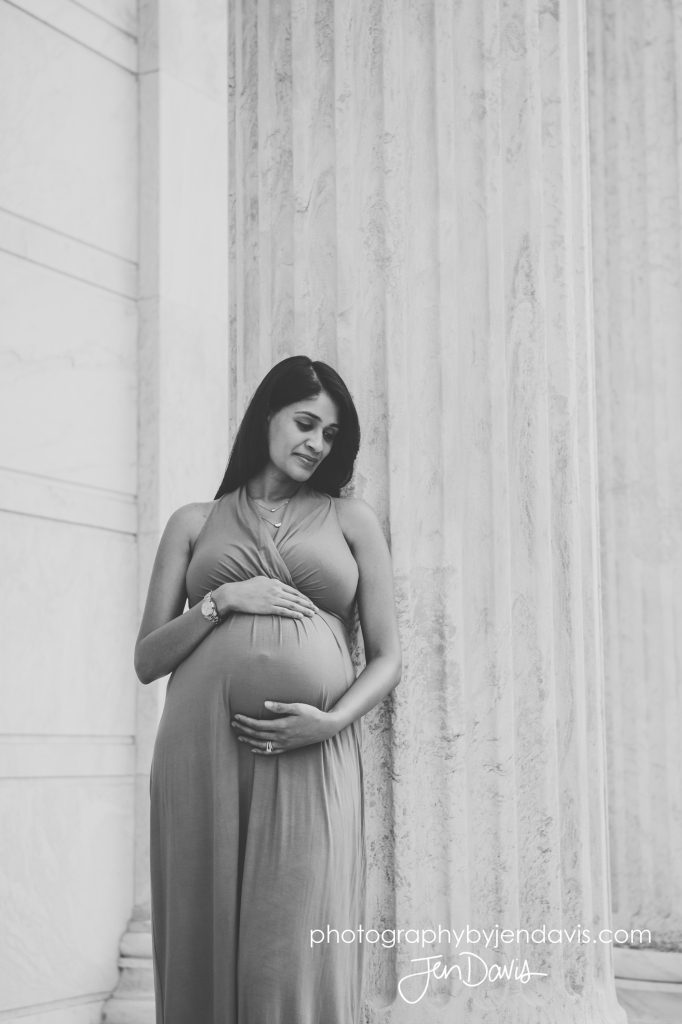 black and white of pregnant woman leaning on a column in princeton