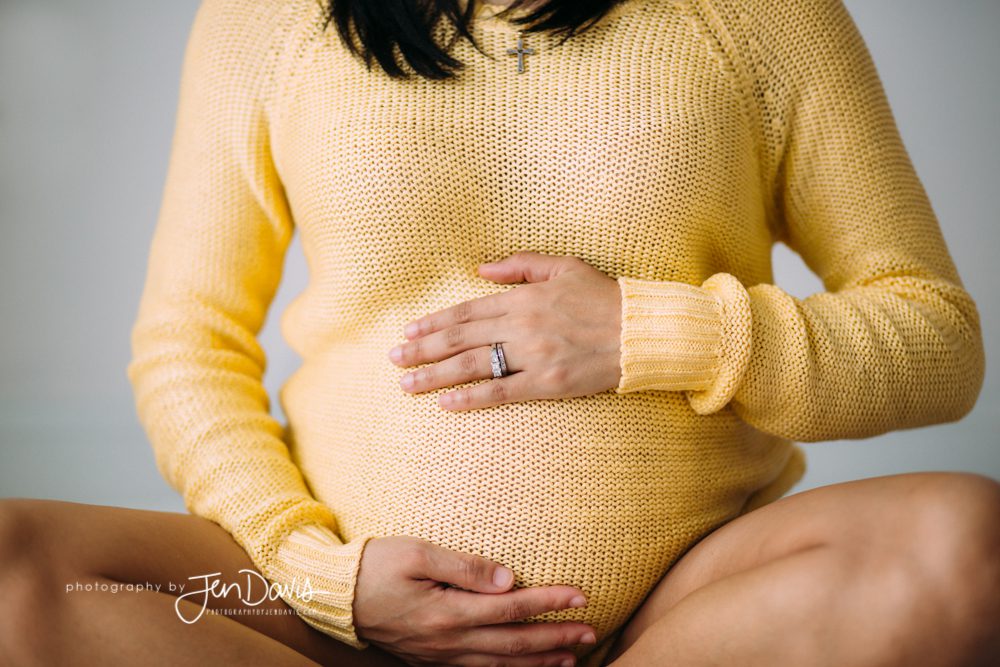Pregnant Woman sitting with yellow sweater