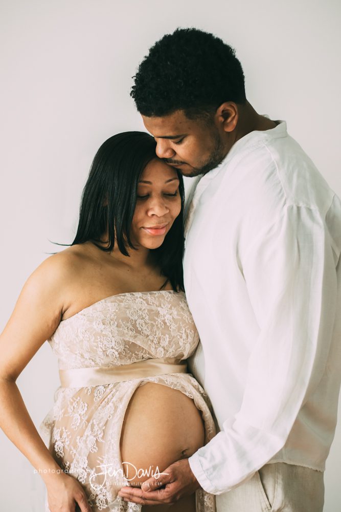 pregnant woman and husband holding belly