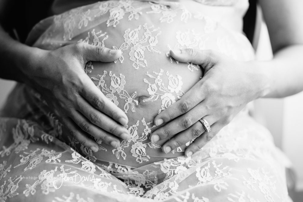 pregnant woman with lace on her belly in black and white