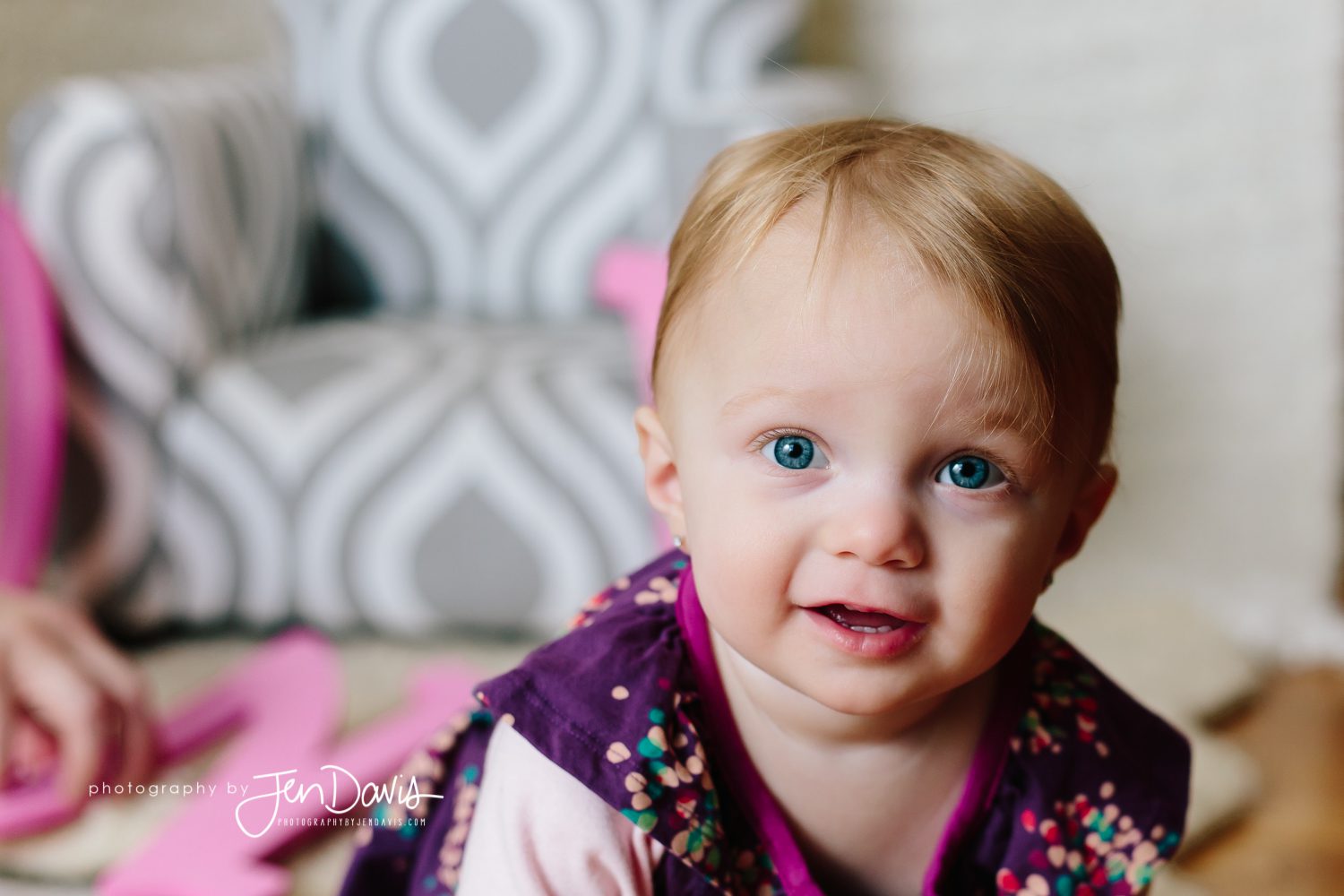 One year old girl with blonde hair and blue eyes