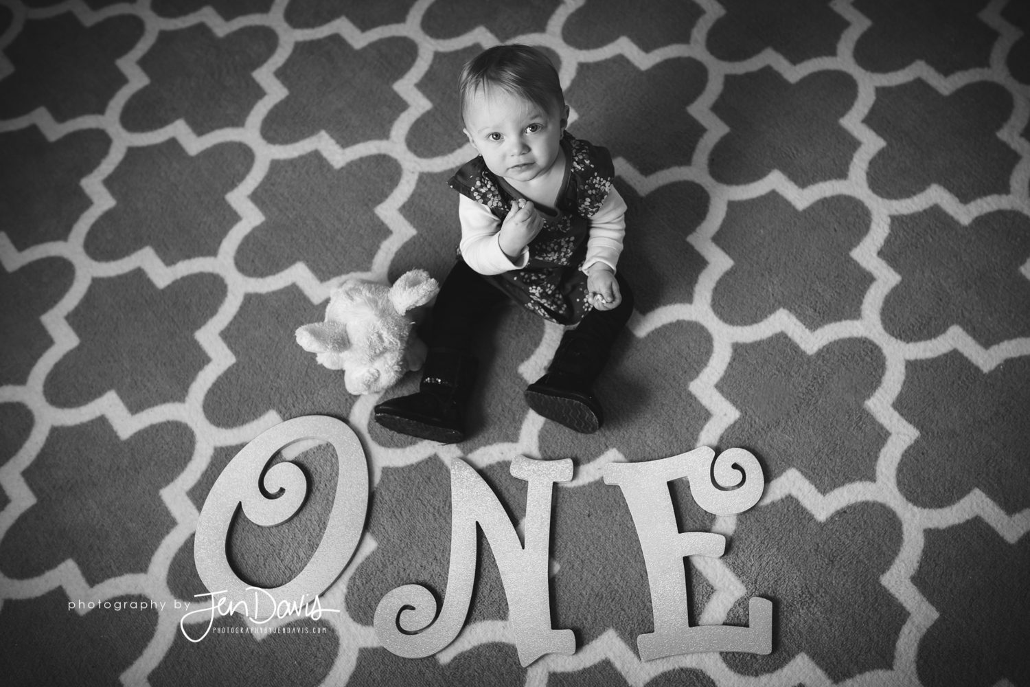 black and white image of one year old girl with one letters