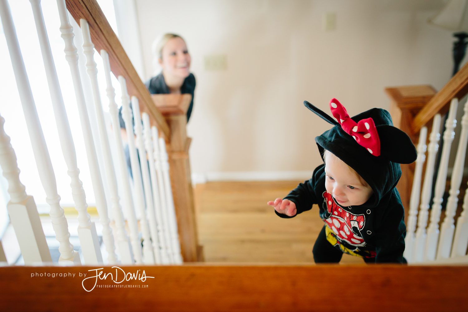 One Year Old Climbing steps with minnie mouse sweatshirt