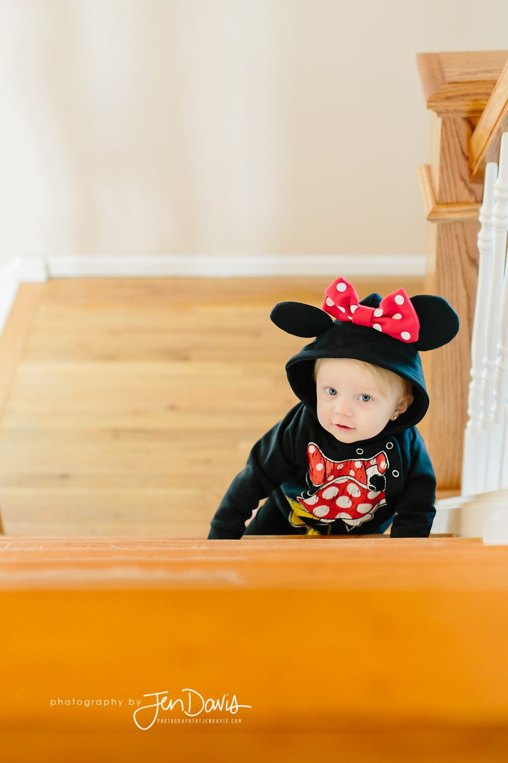 One Year Old climbing steps with minie mouse sweatshirt