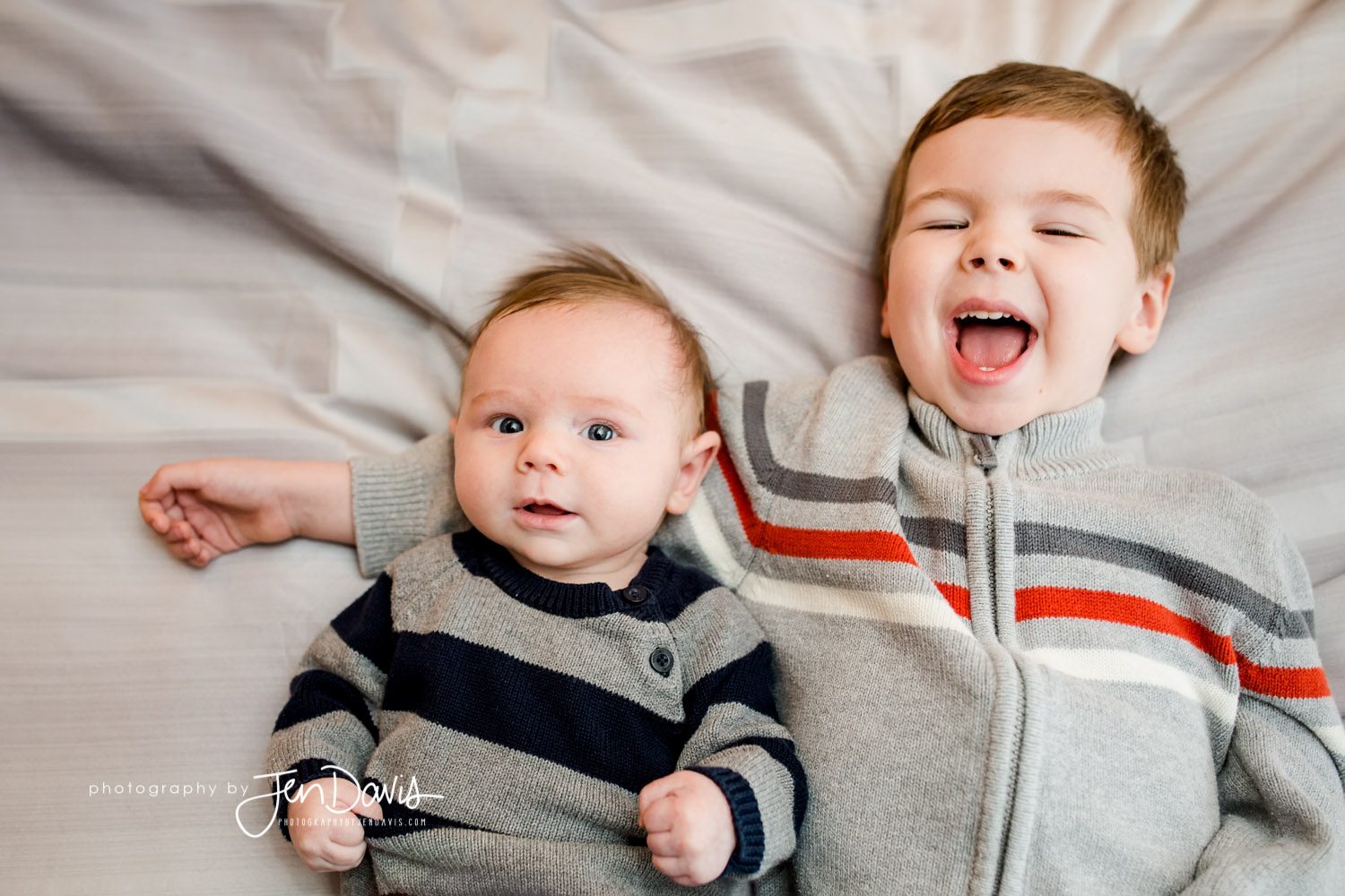 big brother and baby laughing