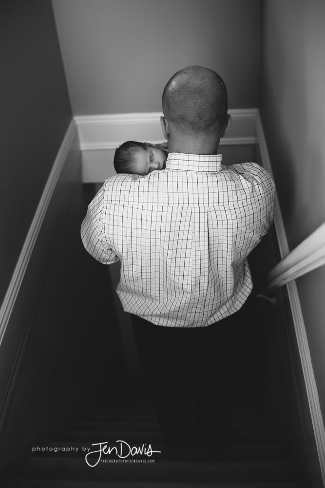 Dad holding baby walking down the steps