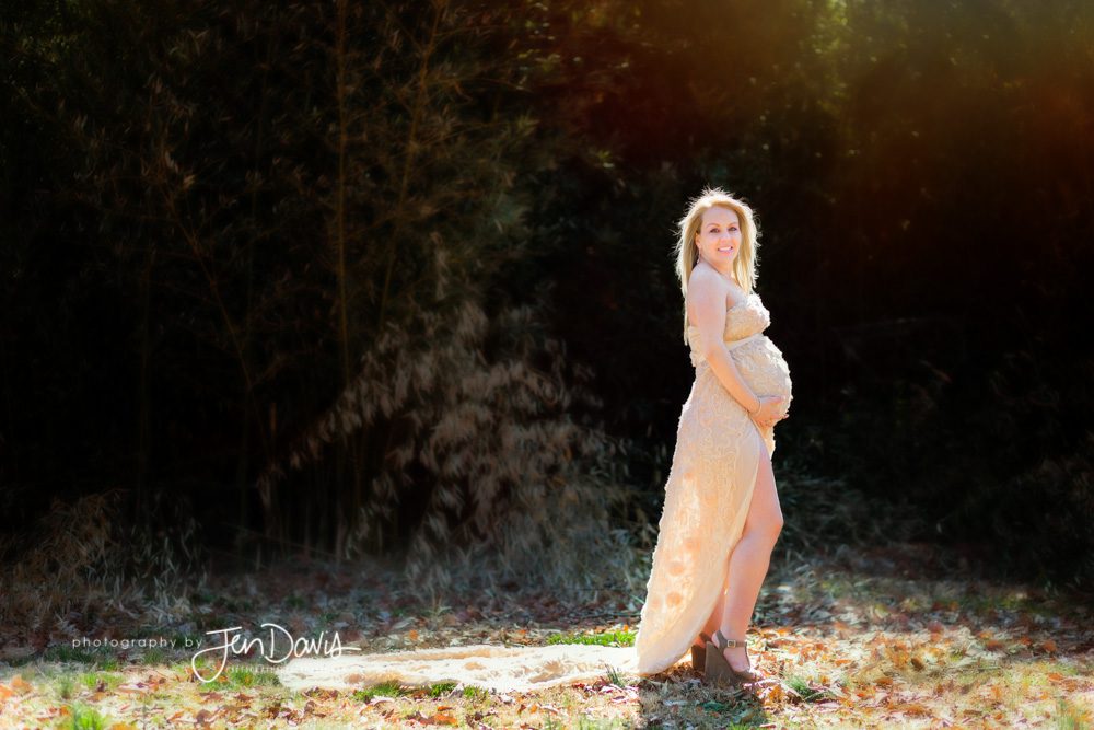 pregnant woman in the woods draped in fabric