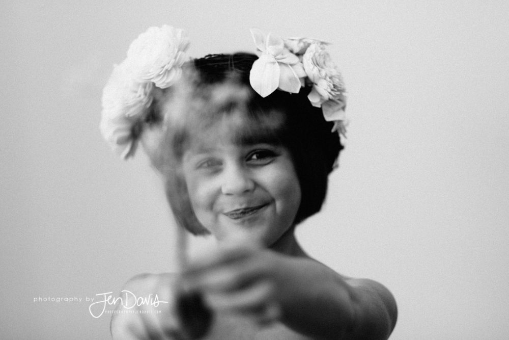 Little girl with baby's breath and crown in black and white