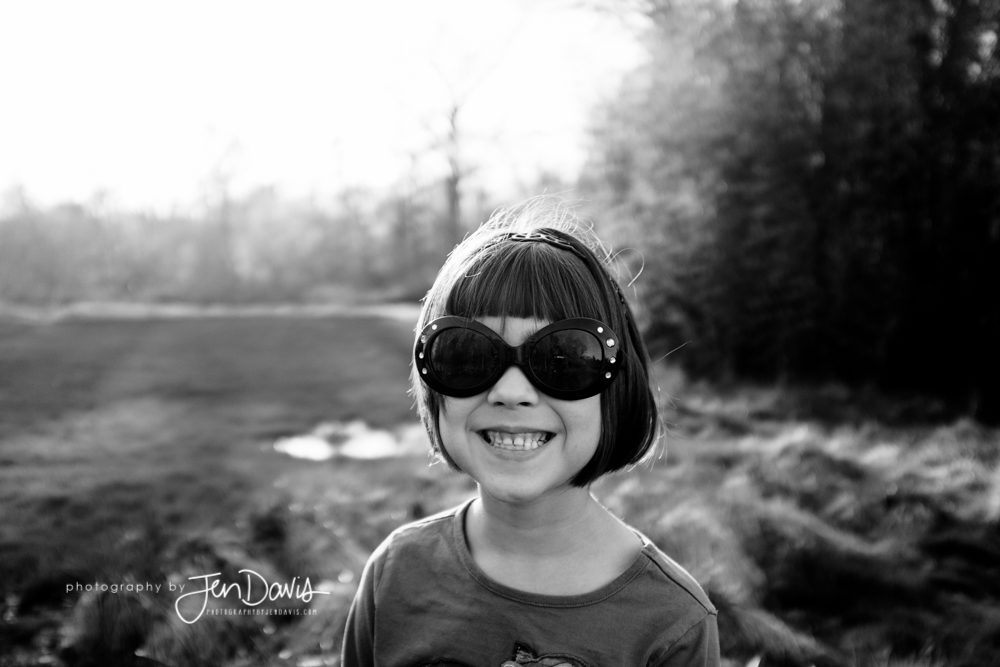 little girl smiling in black and white