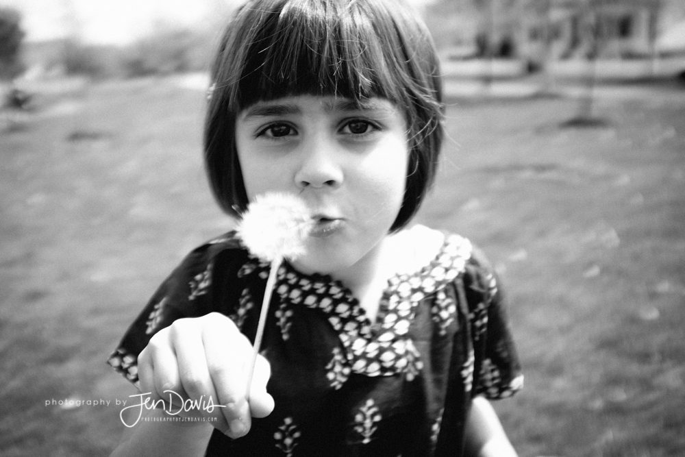 black and white of girl with a dandelion