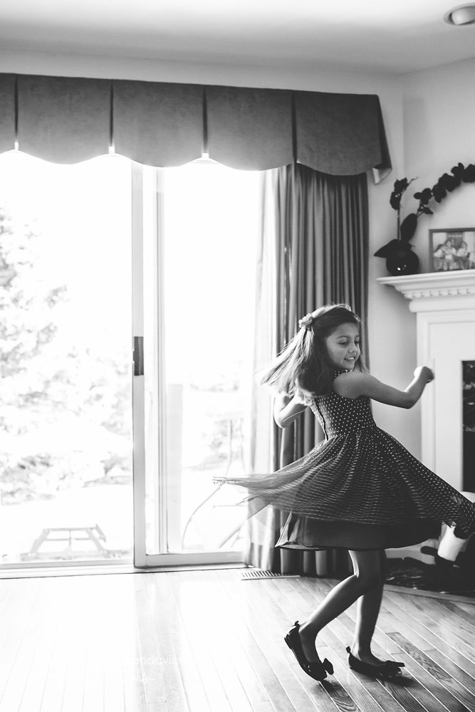 girl dancing in living room black and white
