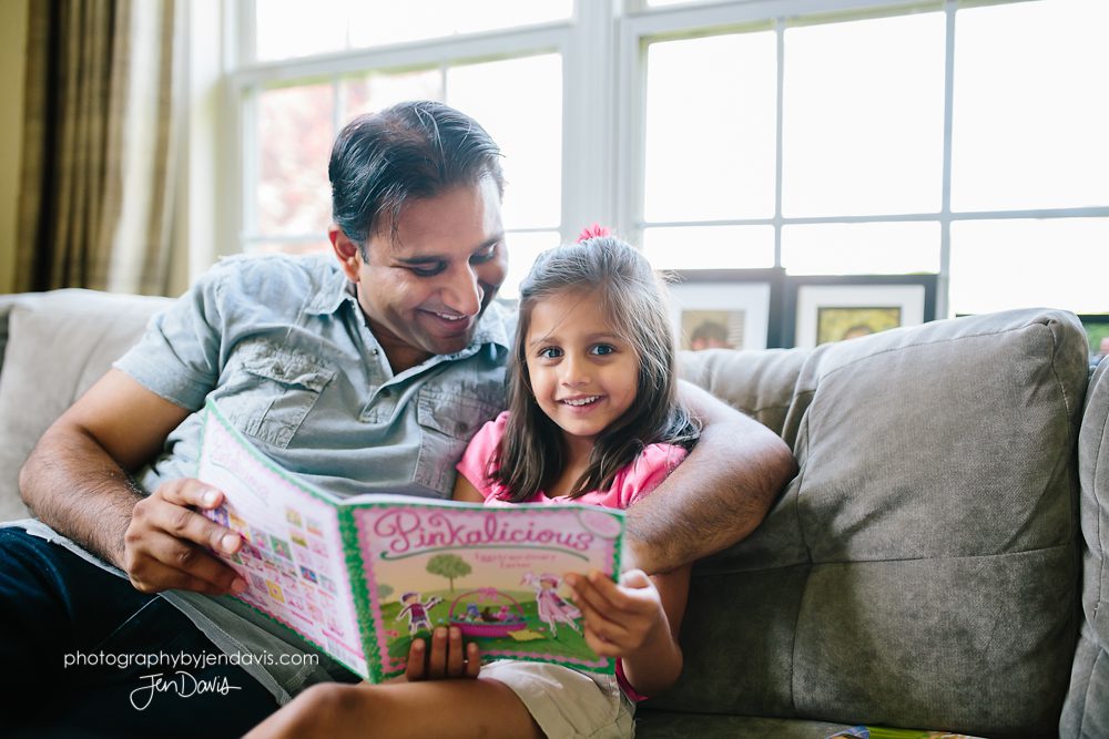 Father and daughter reading a book