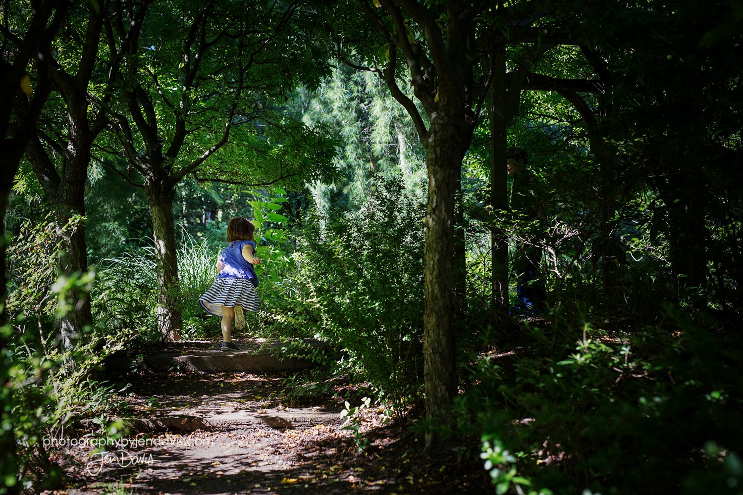Little girl running through the woods