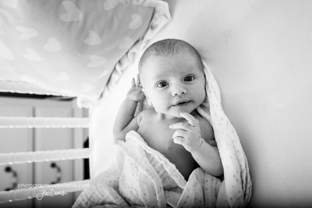 black and white of baby in a crib