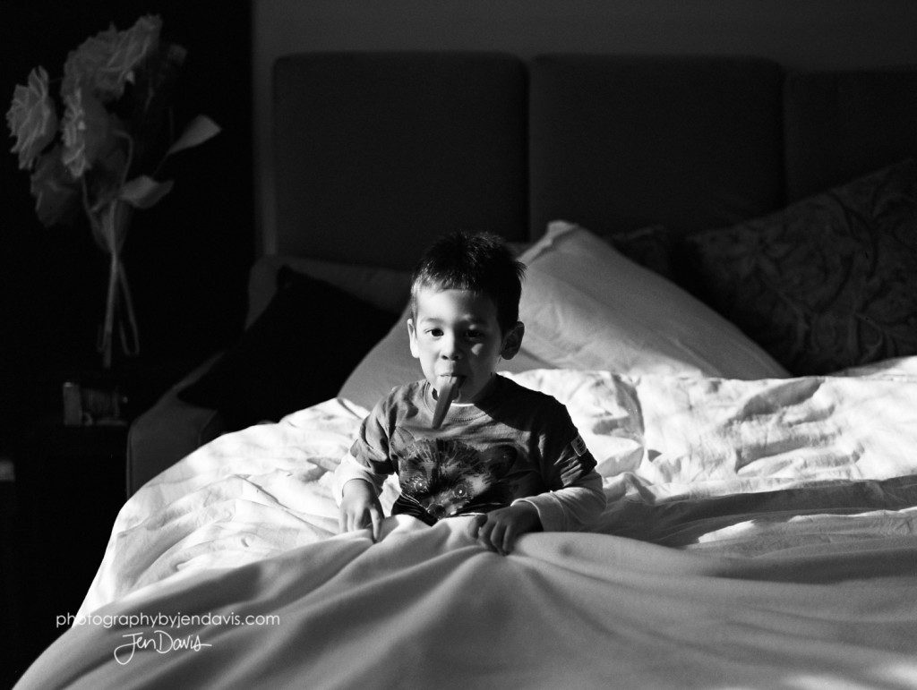boy blowing whistle in bed