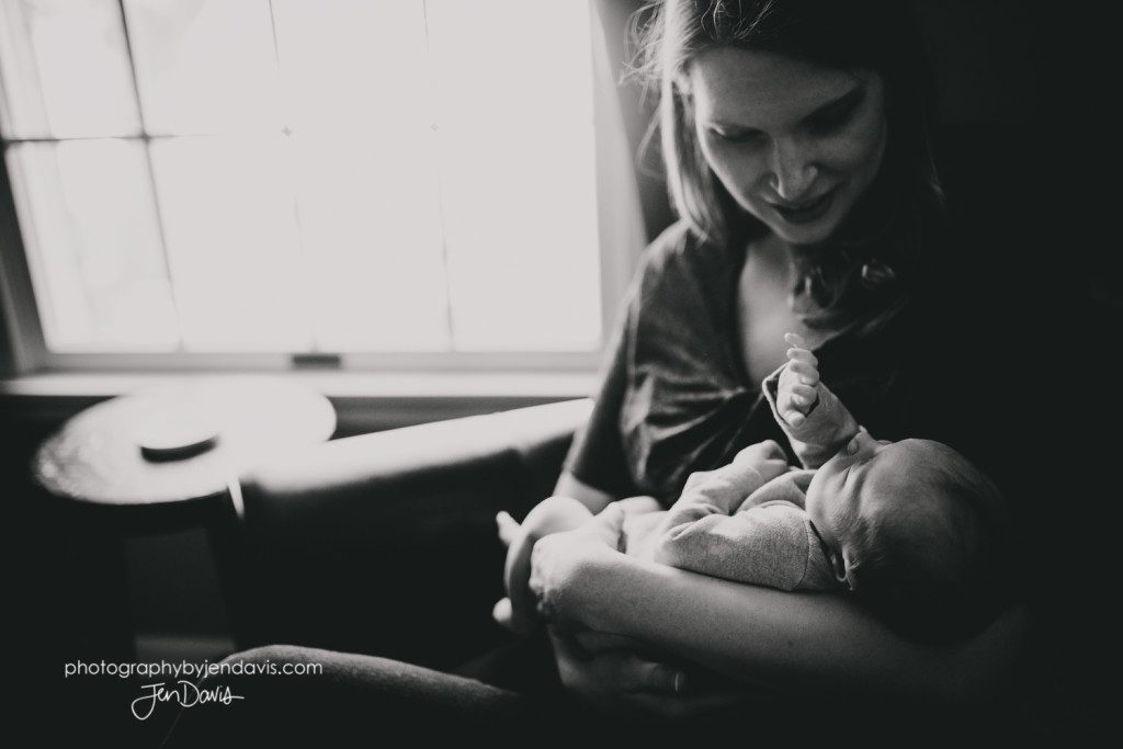 mom and baby by a window in black and white
