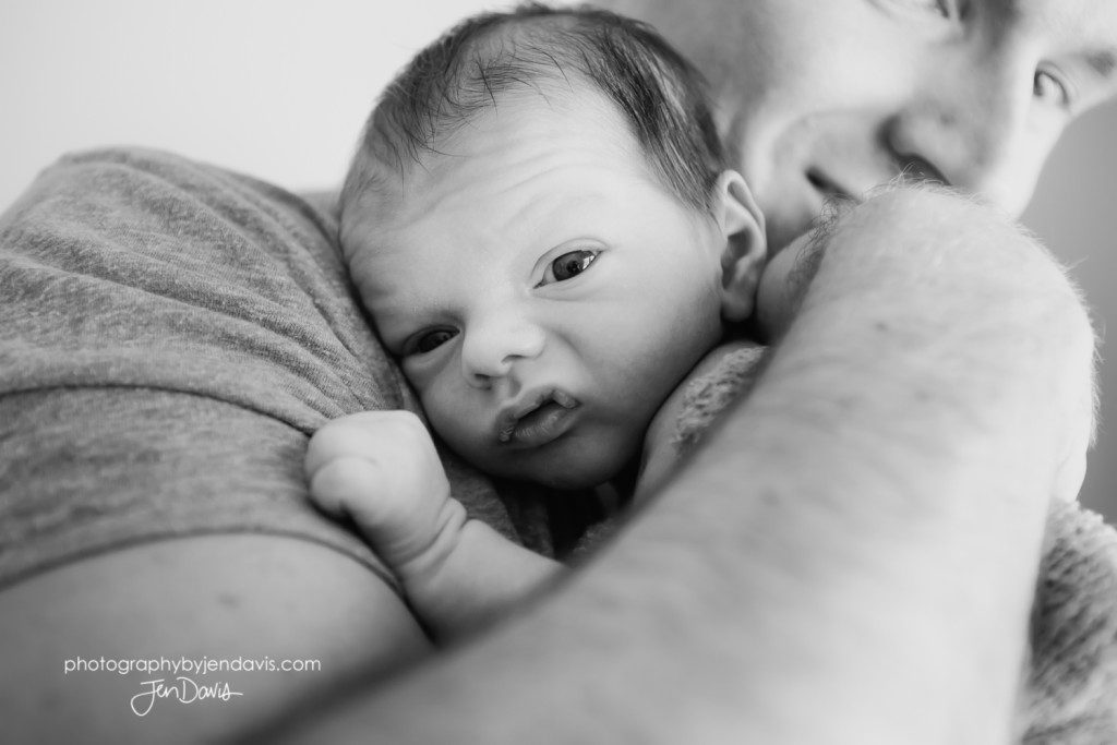 black and white of dad holding baby