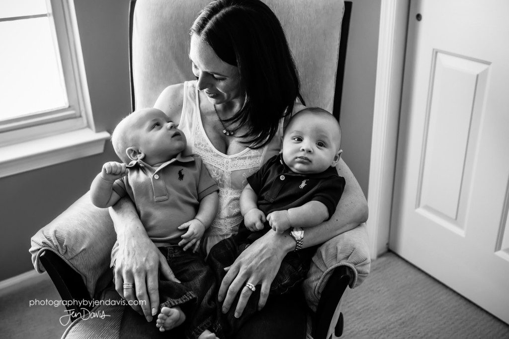 black and white of mom holding twins