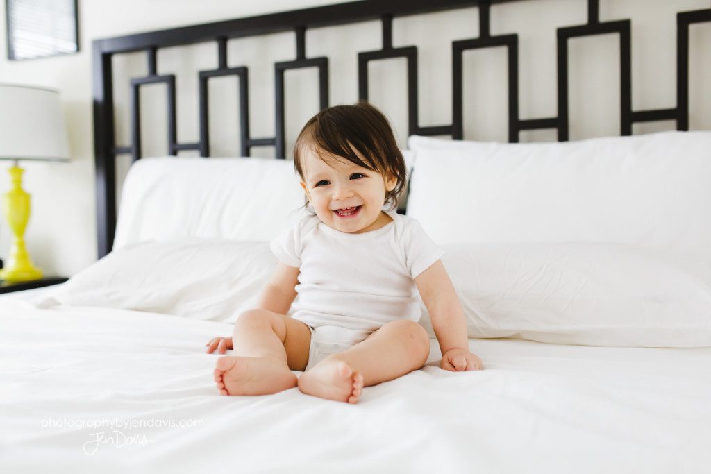 1 year old boy on a bed