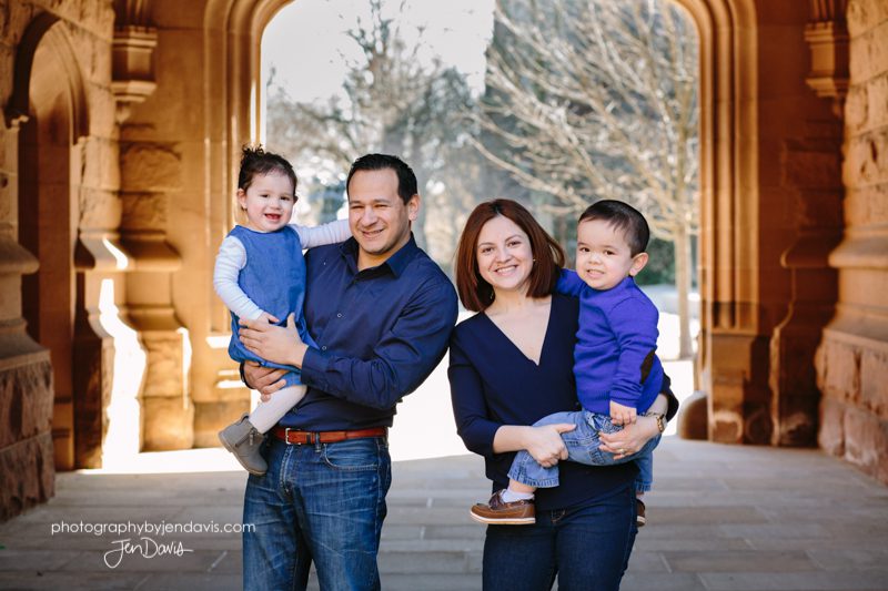 family of 4 smiling in princeton near the arches