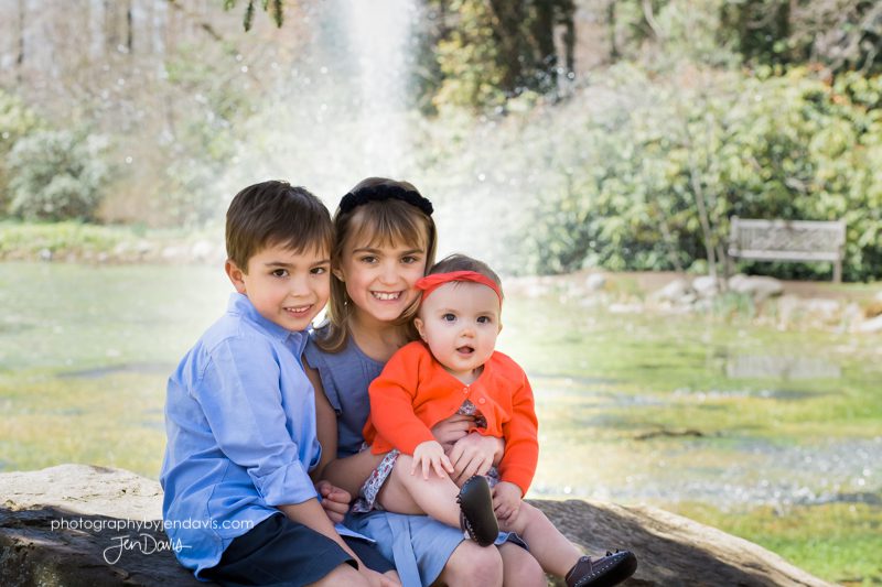 Siblings sitting on a rock by the pond at Sayen Gardens, Hamilton NJ
