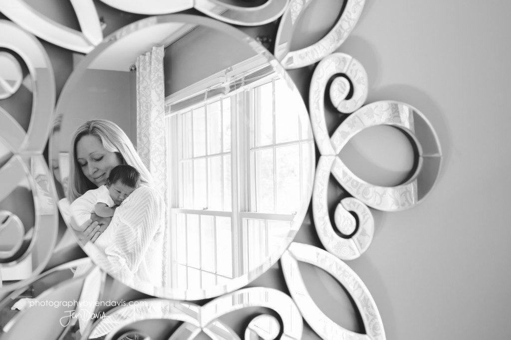 Mom and baby in mirror in black and white