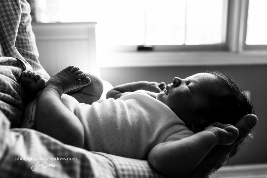 Dad cradling baby, profile shot black and white