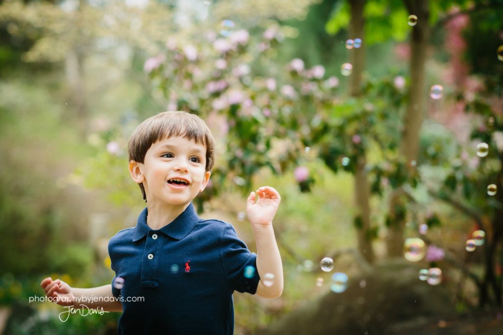 2 year old boy popping bubbles