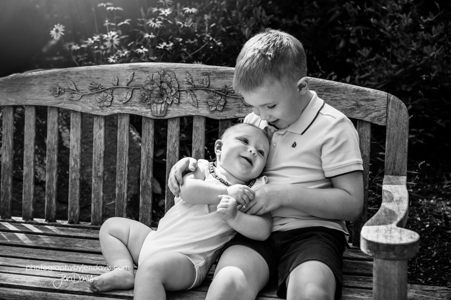 black and white of brother and sister on bench