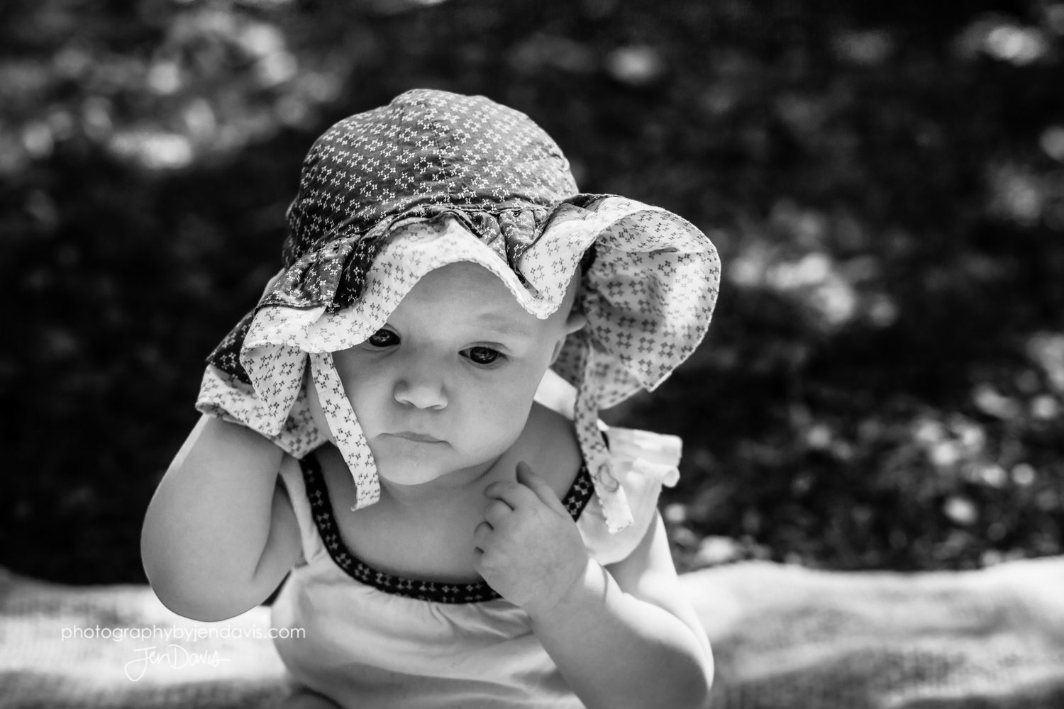 black and white of baby wearing hat