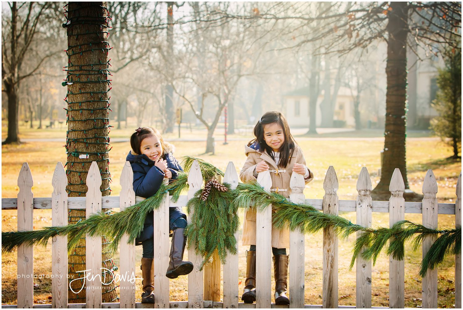 Family standing by fence with garland