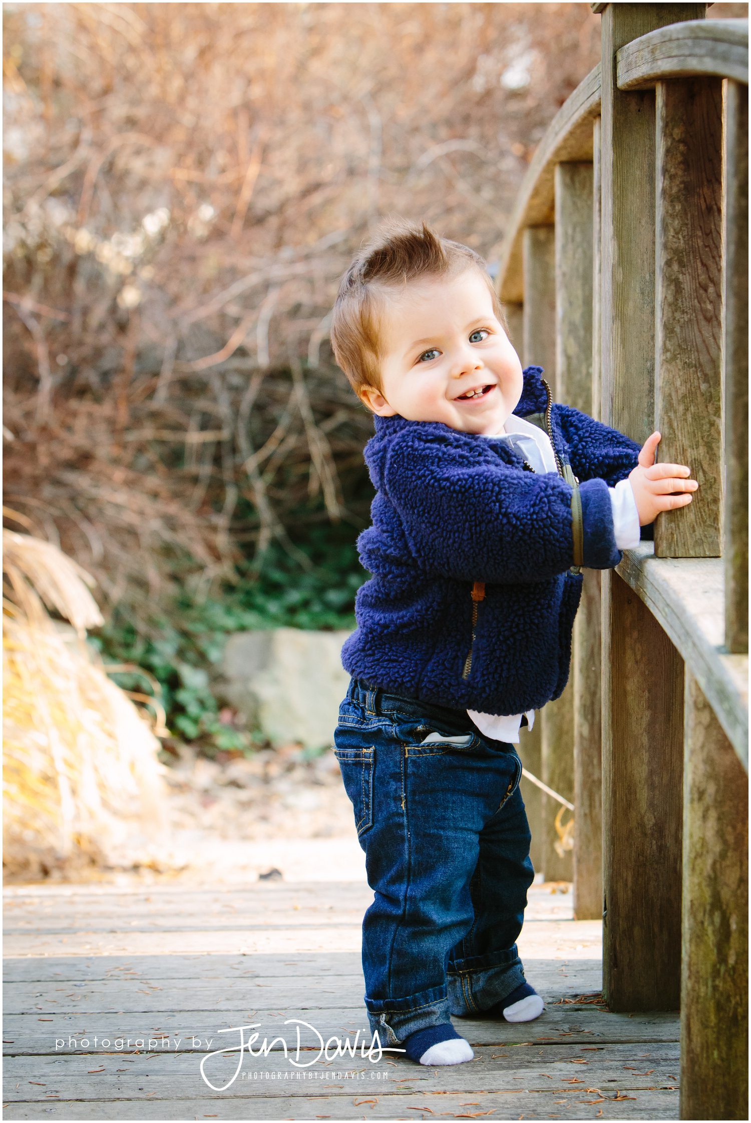 1 year old standing on wooden bridge