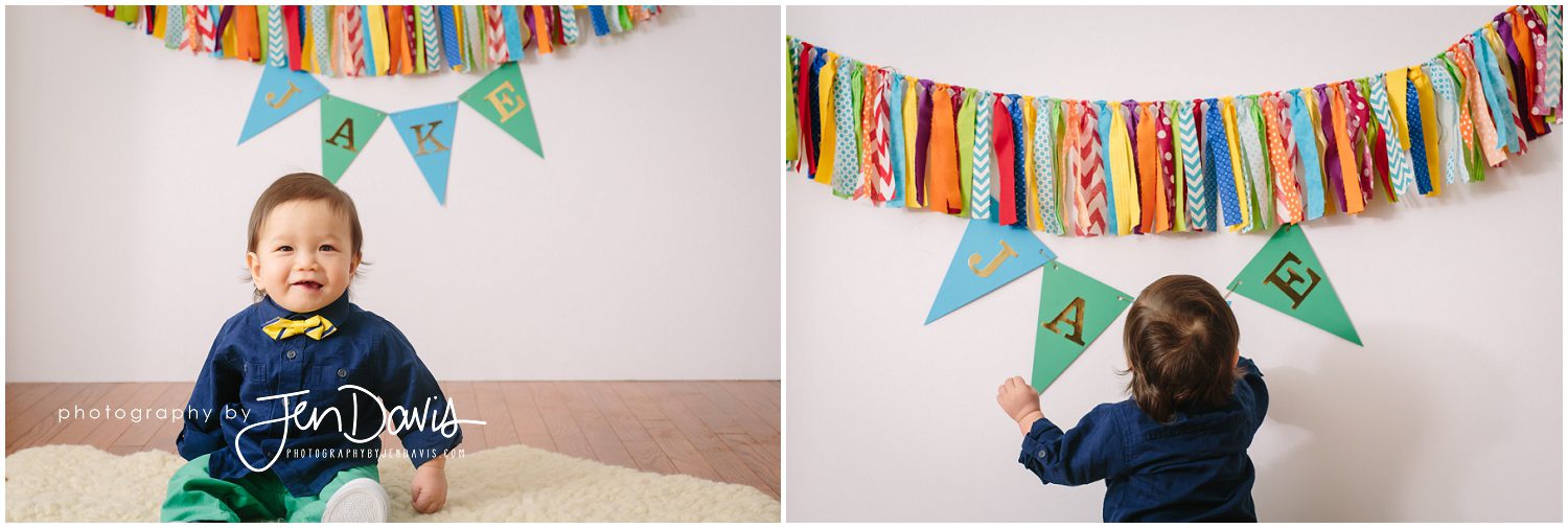 1 year old boy with birthday banner