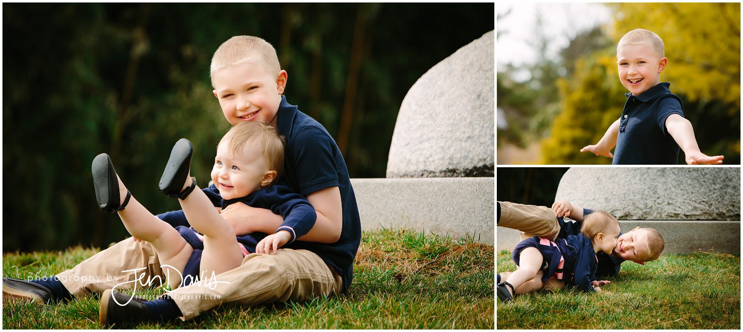 Siblings hugging and playing in the grass