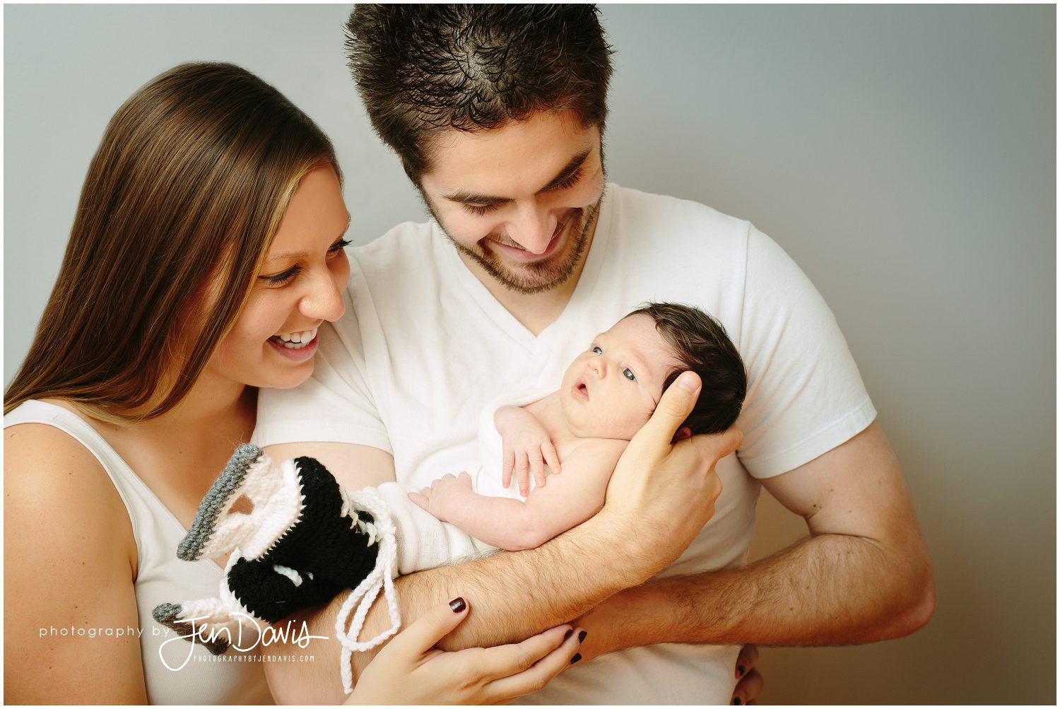 newborn posing with mom and dad