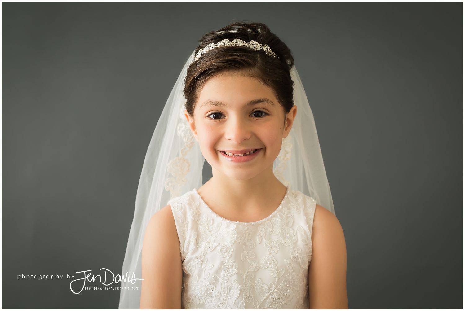 little girl in communion dress in portrait studio
