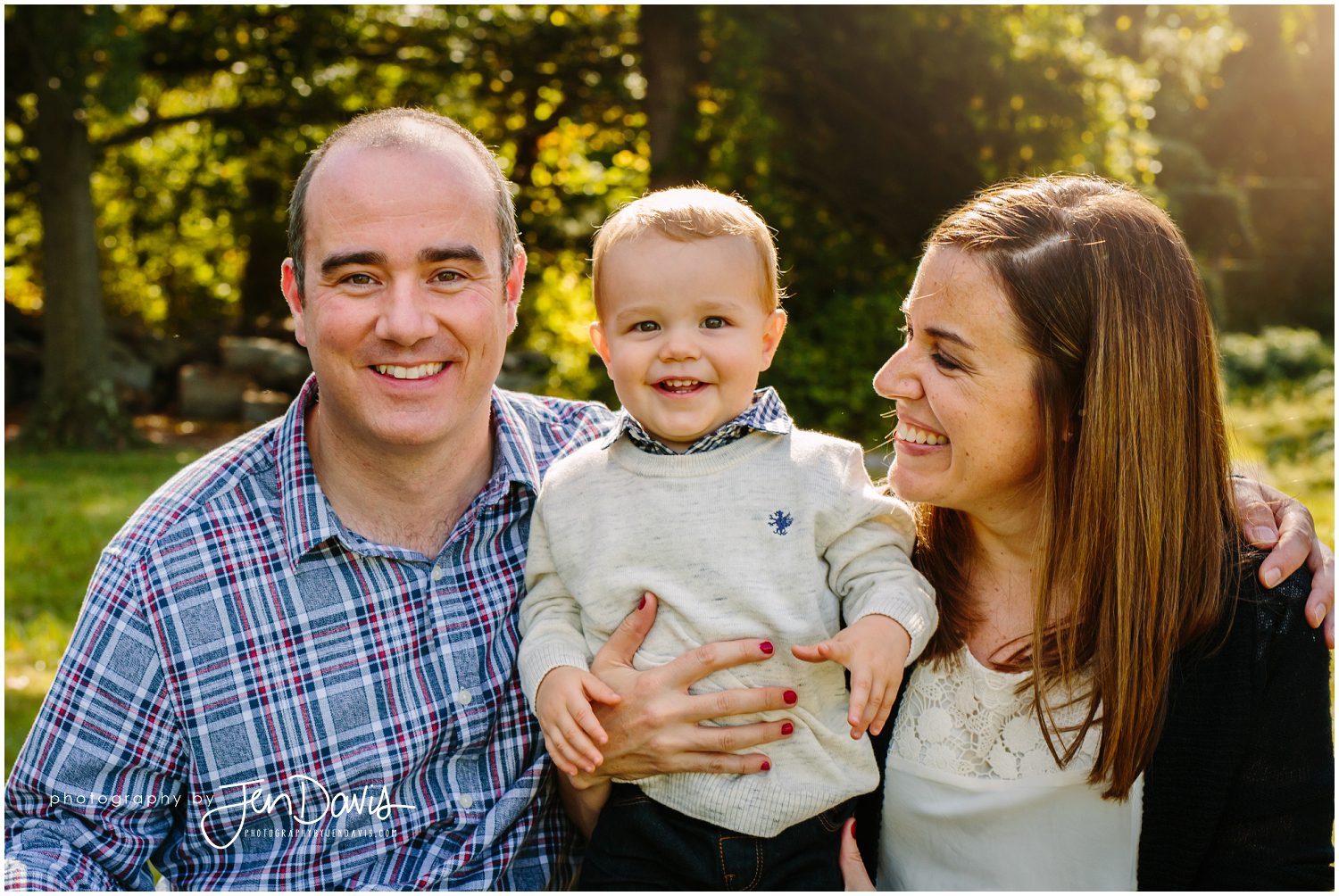 family smiling for pictures in fall